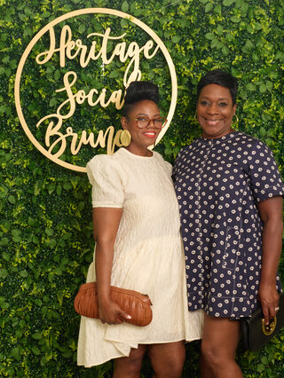 Two guests pose together at Heritage Social Brunch