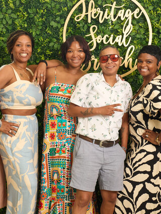 A group of guests gather at the Heritage Social Brunch welcome wall